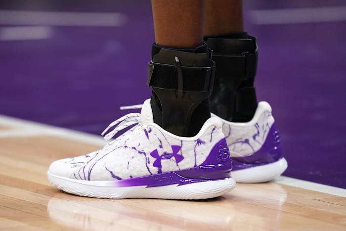 Sacramento Kings guard De'Aaron Fox's purple and white Under Armour sneakers.